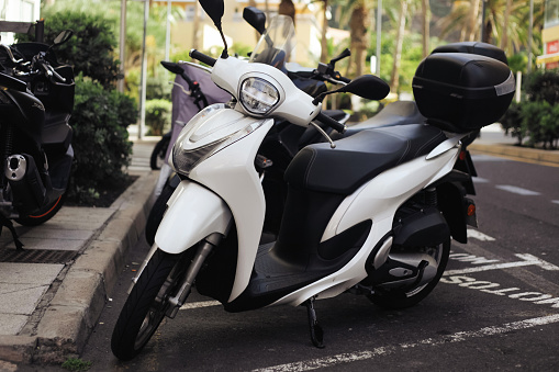 motorcycles standing in the row on asphalt road closeup