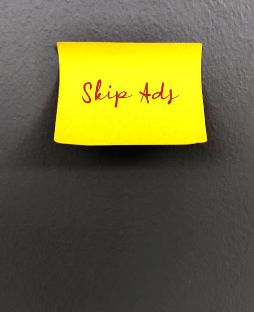 istock Yellow stick note on grey background with text SKIP ADS ,easy way to skip annoying online ads, unwanted commercial which seek our attention, action to avoid them 1951650101