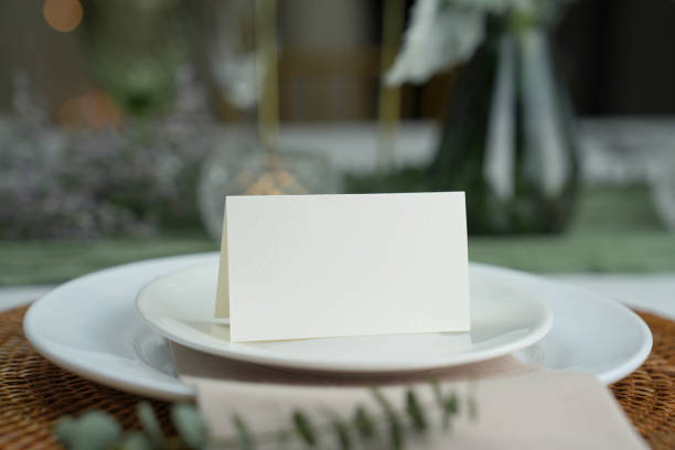 istock Mockup white blank space card, for Name place, Folded, greeting, invitation on wedding table setting background. 1951654400