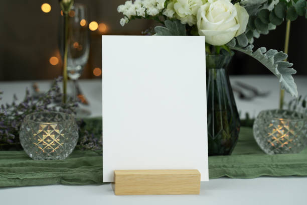 istock Mockup white blank space card, for greeting, table number, wedding invitation template on wedding table setting background. 1951654401