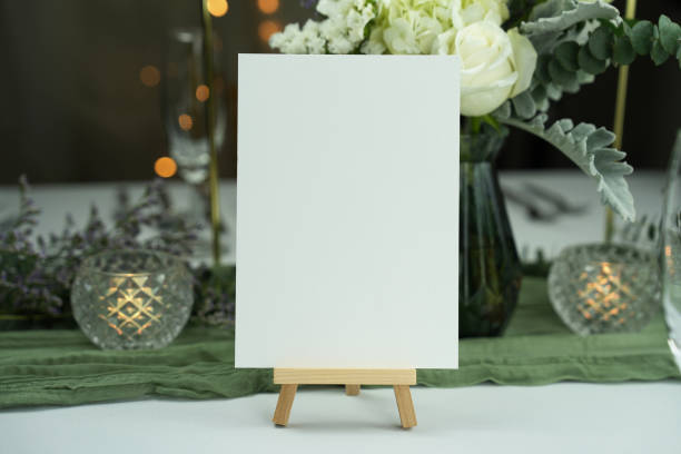 Mockup white blank space card, for greeting, table number, wedding invitation template on wedding table setting background.