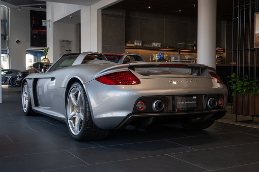 Amsterdam, The Netherlands - February 9, 2005: Silver Mercedes McLaren SLR on display at the 2005 Amsterdam Motor Show. People in the background are looking at the cars.