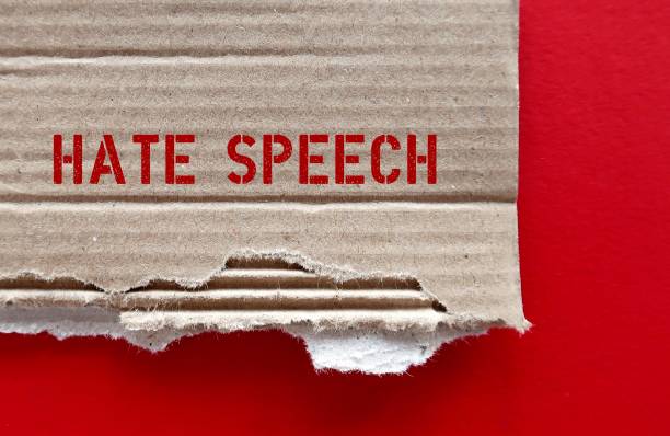 istock Torn brown cardboard paper with red text HATE SPEECH on red background, concept of expression which speakers intend to humiliate or promote hatred, violence and discrimination against group or class of persons 1951670926