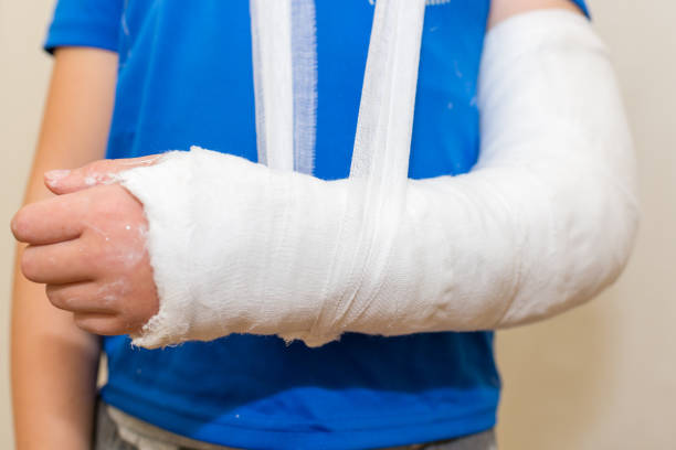 Boy, child,kid with plastered hand on white background.Close-up.