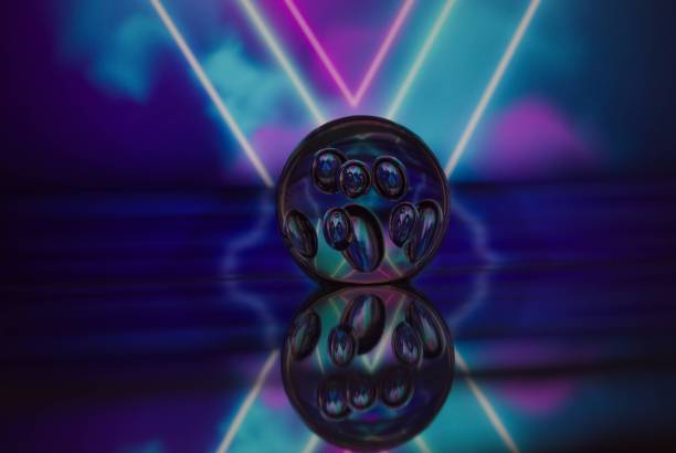 istock Glass marble sphere illuminated by vibrant neon lights 1951708883