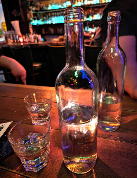 istock glass bottles and cups lit by candlelight 1951713497