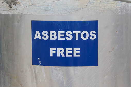 A blue sign with the text: Asbestos free, at an industrial gas plant