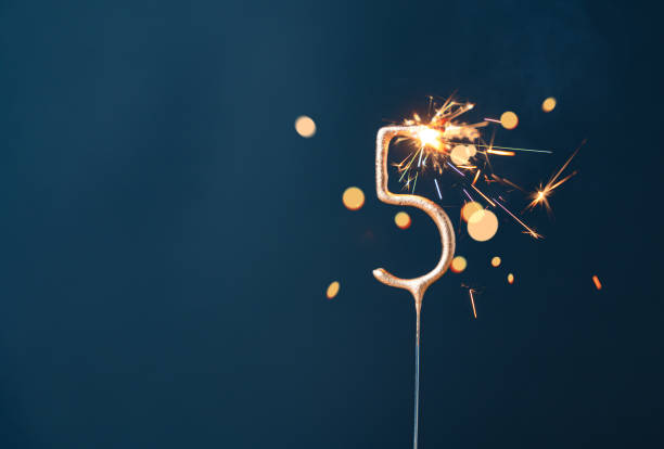 istock 5 years celebration festive background with copy space made with Bengal fire in the form of number Five. 1951740843