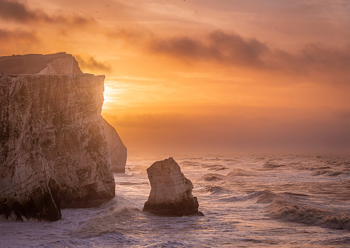 Storm Isha brewing at Seaford head on the east Sussex coast during high tide and sunrise south east England UK