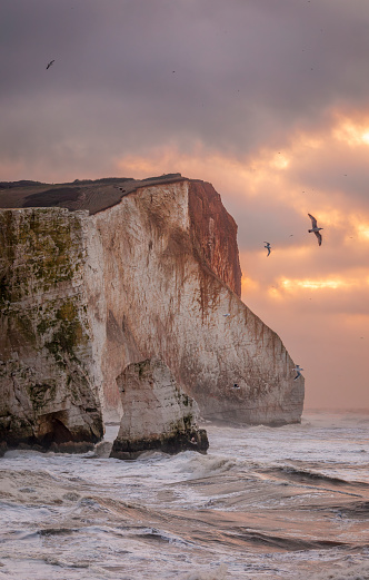 Storm Isha brewing at Seaford head on the east Sussex coast during high tide and sunrise south east England UK