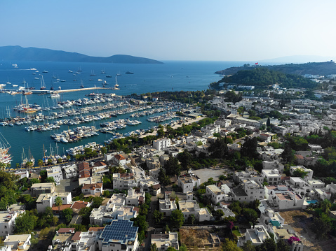 Drone view of the charming city of Bodrum, marina with yachts on a sunny day. Beautiful urban landscape of Bodrum, Turkey.