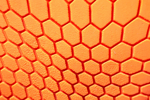 Orange hexagon pattern background Is a rubber decorated closeup.Orange hexagon abstract background texture.Macro indoors shot.