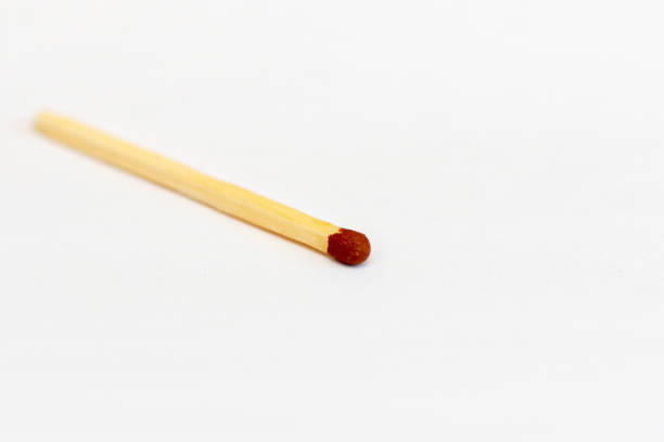 Close-up view of a matchstick that has just been ignited, with the flame brightly burning at its tip.