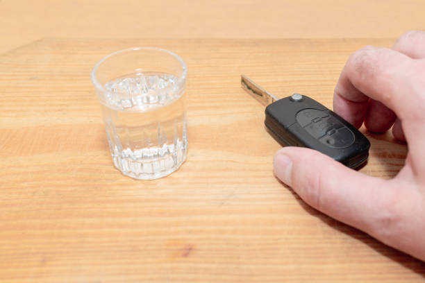 drunk driving - the cause of car accidents. hand reaches for car key and alcohol.drink. male hands and auto keys. - drunk driving alcohol key law 뉴스 사진 이미지