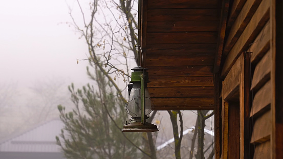 Vintage hanged lamp, outdoor porch light in foggy and cold weather