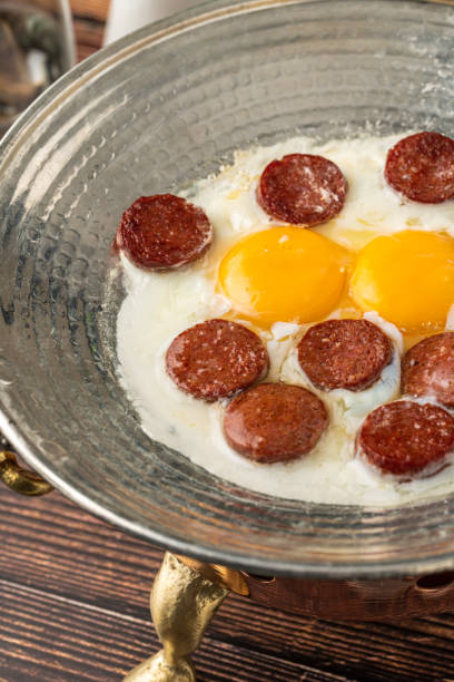 istock fried eggs with turkish sausage with bread and tea on wooden table 1951761741