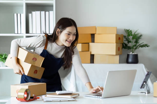 istock Young business entrepreneur using laptop. Preparing for shipping, online selling, e-commerce concept 1951773760