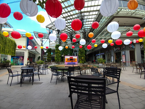 Bekasi, Indonesia -  January 19 2024: An outdoor dining table in a shopping center decorated with lanterns is suitable for relaxing with friends or family