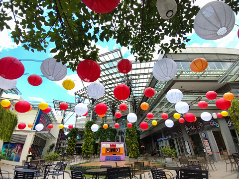 Bekasi, Indonesia -  January 19 2024: An outdoor dining table in a shopping center decorated with lanterns is suitable for relaxing with friends or family