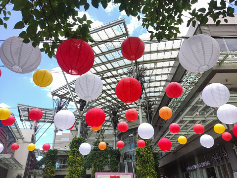 Bekasi, Indonesia -  January 19 2024: An outdoor dining table in a shopping center decorated with lanterns is suitable for relaxing with friends or family