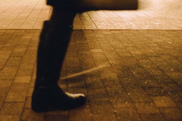 Image of feet in long boots walking away quickly