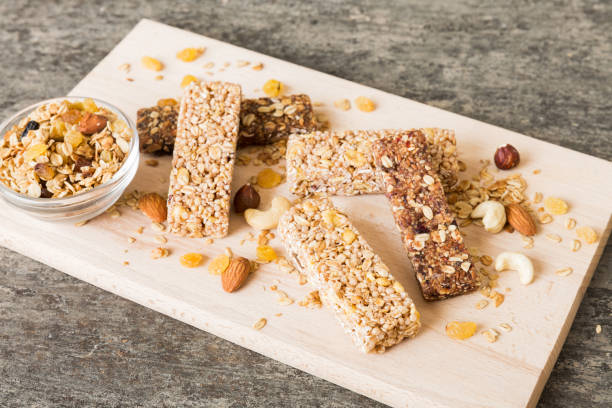 istock Various granola bars on table background. Cereal granola bars. Superfood breakfast bars with oats, nuts and berries, close up. Superfood concept 1951815905