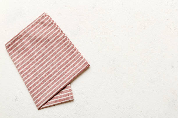 istock top view with red empty kitchen napkin isolated on table background. Folded cloth for mockup with copy space, Flat lay. Minimal style 1951815934