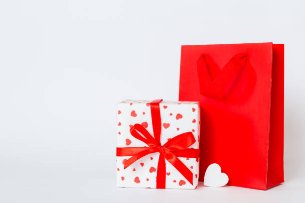 istock Shopping bag with gift box on colored background perspecrive view. Space for text holiday concept 1951816465