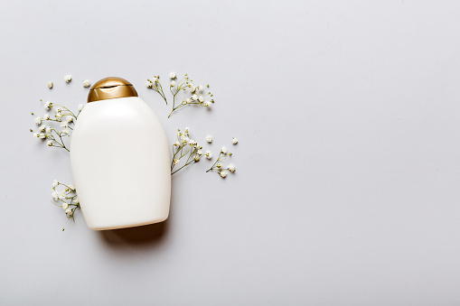 Fancy healthcare bottles for cream with gypsophila branch. Natural oranic spa cosmetics concept. Mockup, template, Top view.