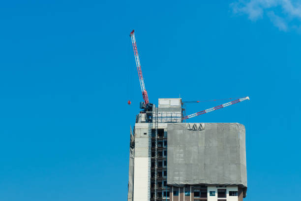 istock Crane and building construction site against blue sky. 1951817588