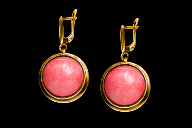 Vintage golden coral earrings isolated on black background