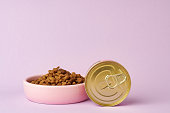 Cat food on pink background in studio
