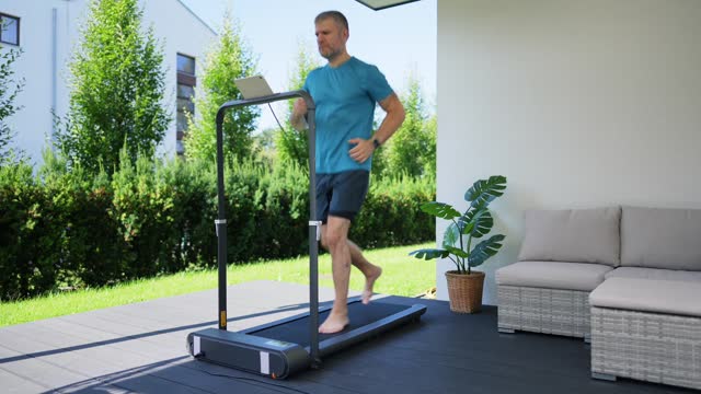 Man running on a treadmill at the yard