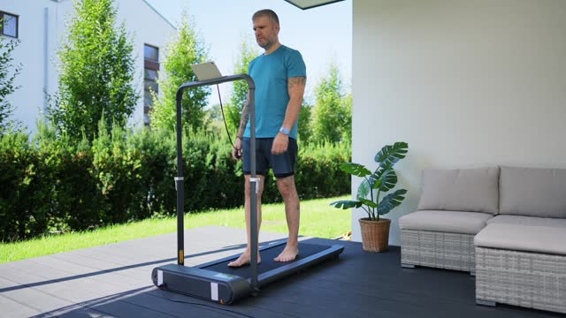 Man walking on a treadmill at the yard