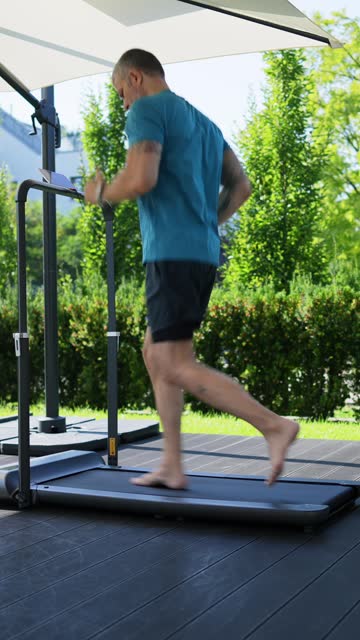 Man running on a treadmill at the porch of his house
