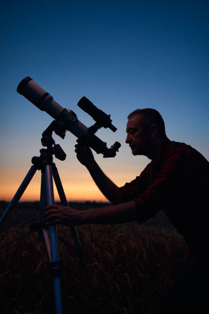 istock Astronomer looking at night sky with a telescope. 1951838935