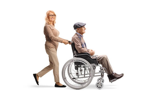 woman pushing a senior man in a wheelchair - physical injury men orthopedic equipment isolated on white imagens e fotografias de stock