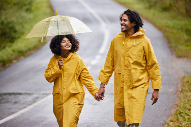 istock Happy black couple walking on rainy day. 1951863953