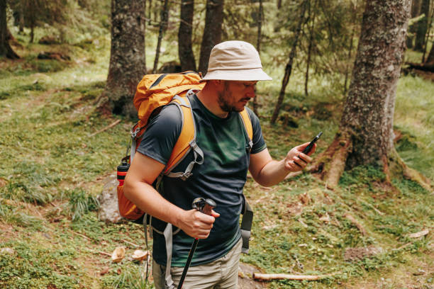 istock Mobile Exploration A Young Traveler Ventures into the Forest with a Smartphone 1951888965