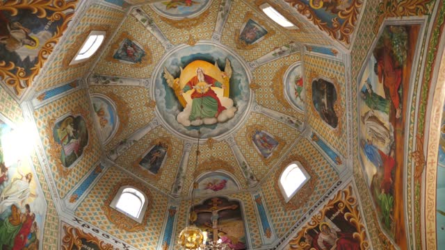 Painting of the dome in the middle of the church. Interior of the temple. Slow motion.
