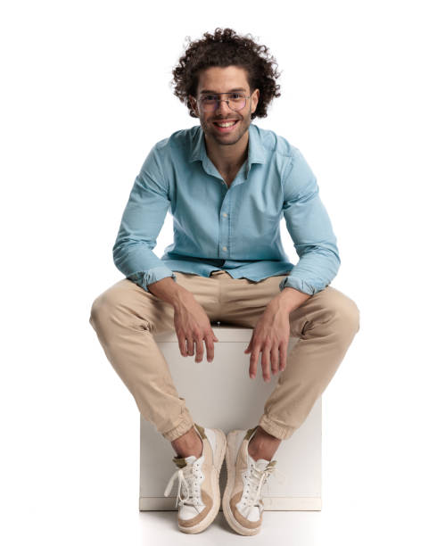 istock seated young casual man smiling 1951906888
