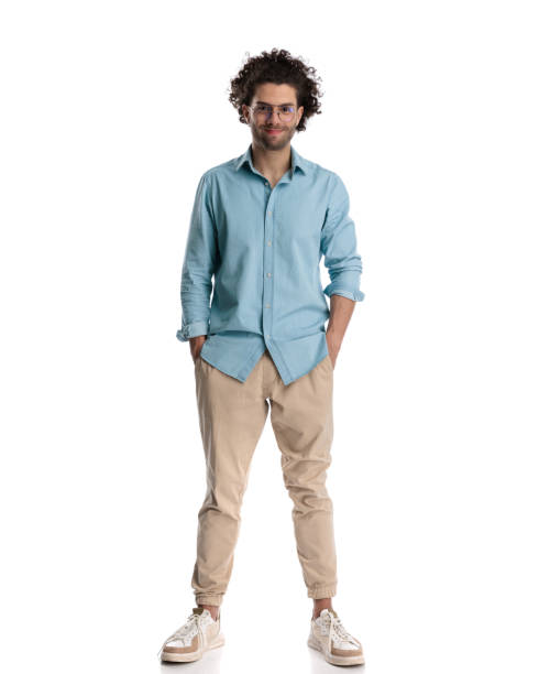 istock casual man wearing blue shirt with hands in pockets 1951907421