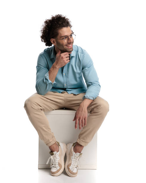pensive casual man sitting and looking to side