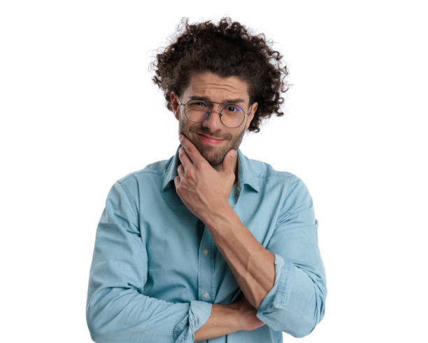 istock pensive casual man holding his chin 1951911639