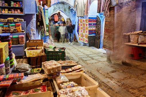 Narrow street with shops at night in the city of Chefchaouen, Morocco, Africa.