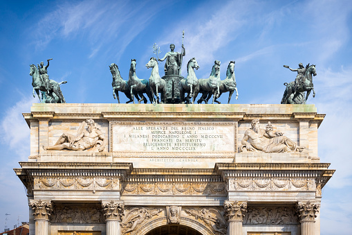 Holidays in Italy -  Arco della Pace in Milan with a sculpture of six horses pulling a chariot with Minerva protecting Peace