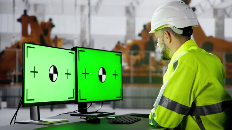 Engineer Using PC Monitor With Green Screen