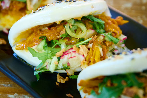 Crispy pork salad roll, Thai food on black plate.