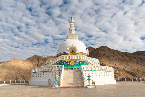 Shanti Stupa is a Buddhist white-domed Stupa on a hilltop in Chanspa near Leh in Ladakh. It was built in 1991 by Japanese Buddhist Bhikshu, Gyomyo Nakamura. The Shanti Stupa holds the relics of the Buddha at its base, enshrined by the 14th Dalai Lama. \nThe Shanti Stupa was built to promote world peace and prosperity and to commemorate 2500 years of Buddhism. It is considered a symbol of the ties between the people of Japan and India.\nThe Stupa has become a tourist attraction not only due to its religious significance but also due to its location which provides panoramic views of the surrounding landscape.\nChanspa, Leh, Ladakh, India, Asia.