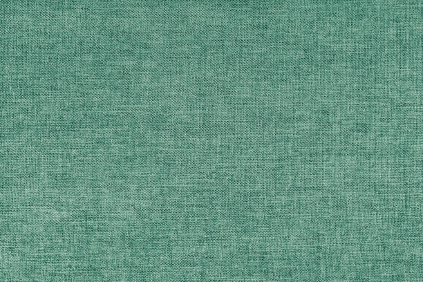istock Textile background, green coarse fabric texture, cloth structure, jacquard woven upholstery 1951980288